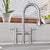 Lead-free solid stainless steel bridge faucet with a gooseneck swivel spout and pull-down spray head